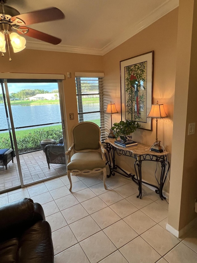 sunroom / solarium with ceiling fan and a water view