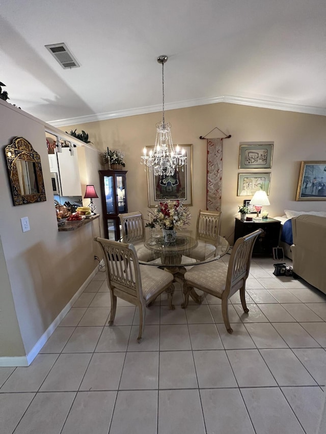 tiled dining space featuring a notable chandelier and crown molding