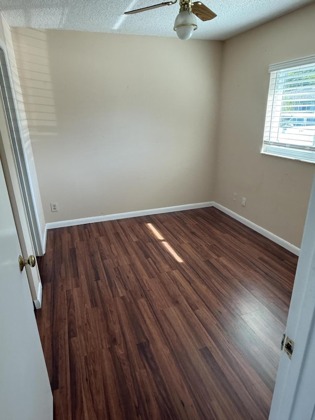 unfurnished room featuring ceiling fan, dark hardwood / wood-style flooring, and a textured ceiling