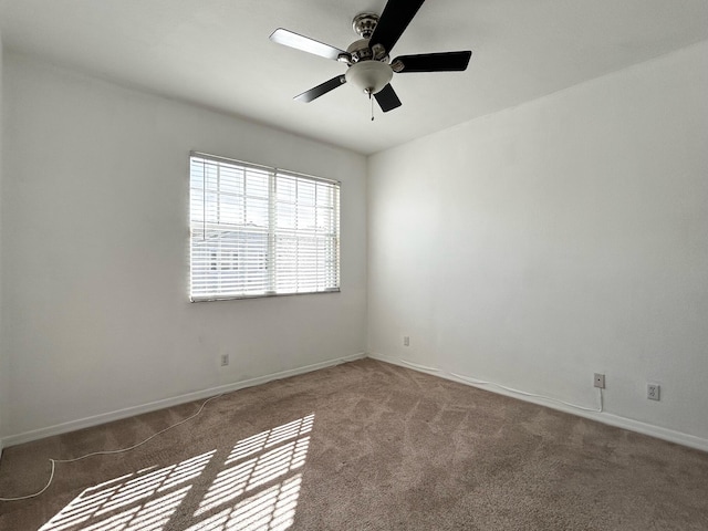 empty room with ceiling fan and carpet floors