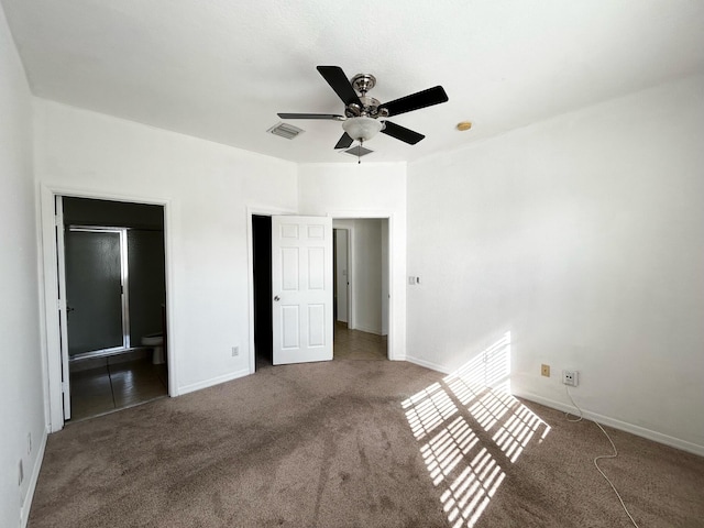 unfurnished bedroom with ensuite bath, ceiling fan, and carpet floors