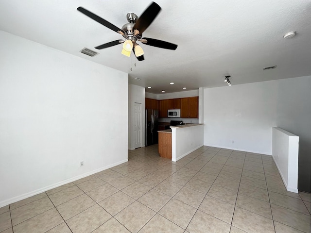 unfurnished living room with ceiling fan and light tile patterned flooring