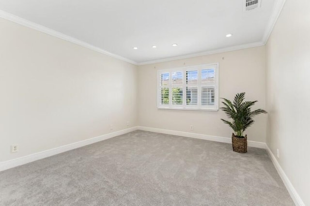 empty room featuring ornamental molding and light colored carpet