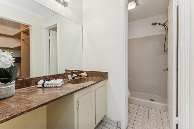 bathroom featuring vanity, tile patterned floors, ornamental molding, and walk in shower