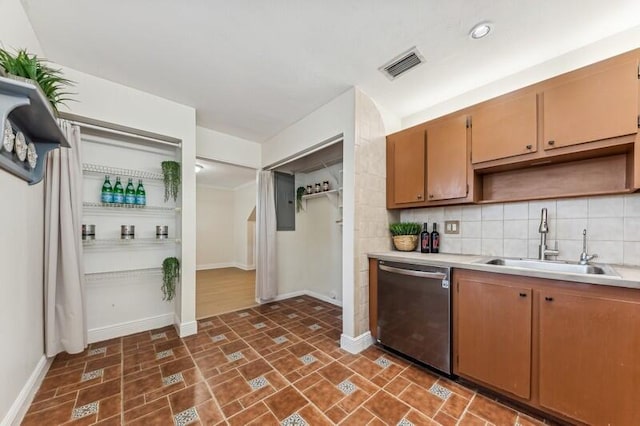 kitchen featuring sink, decorative backsplash, and dishwasher