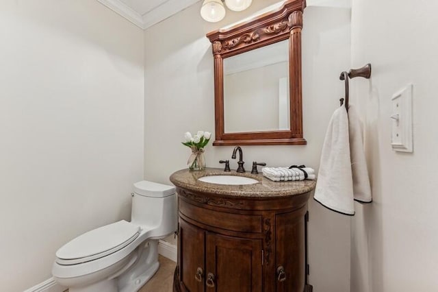 bathroom with vanity, ornamental molding, and toilet