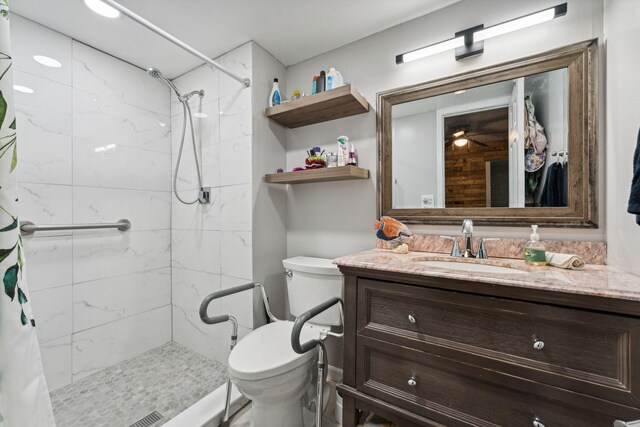 bathroom featuring toilet, a stall shower, and vanity