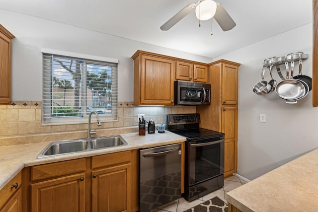 kitchen featuring sink, ceiling fan, decorative backsplash, appliances with stainless steel finishes, and light tile patterned flooring