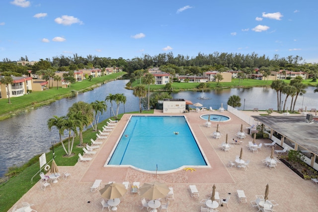 community pool featuring a community hot tub, a patio area, and a water view