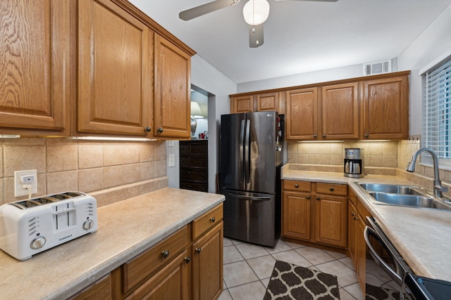 312 Lake Dora Dr, West Palm Beach, FL 33411 - kitchen with freestanding refrigerator, a sink, ceiling fan, dishwasher, and brown cabinets