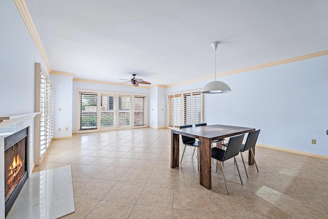 tiled dining space with ceiling fan and ornamental molding