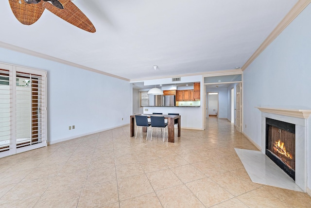 interior space with ceiling fan and crown molding