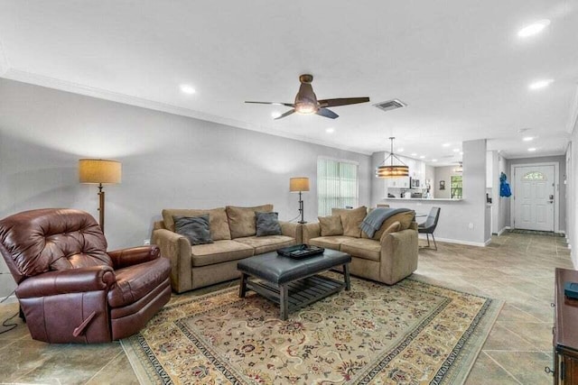 living room featuring ceiling fan and crown molding