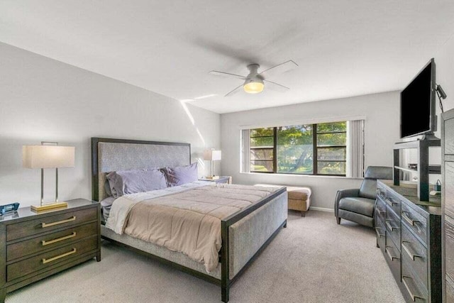 bedroom with light colored carpet and ceiling fan