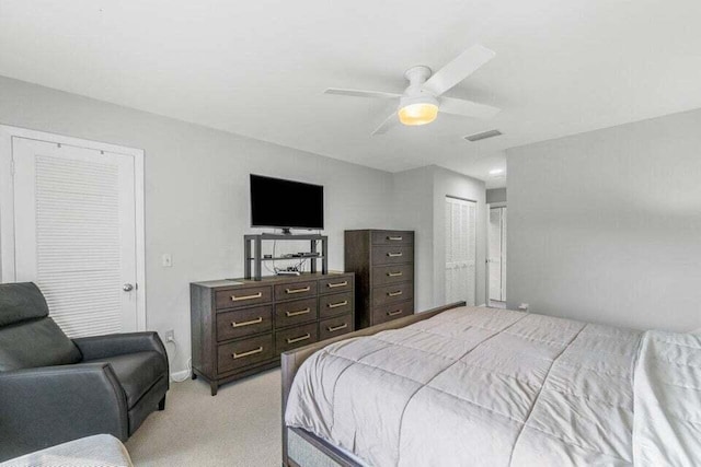 bedroom with ceiling fan and light carpet