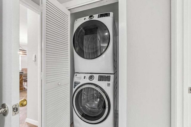 laundry room featuring stacked washing maching and dryer