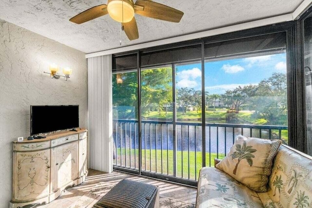 interior space featuring ceiling fan and a water view