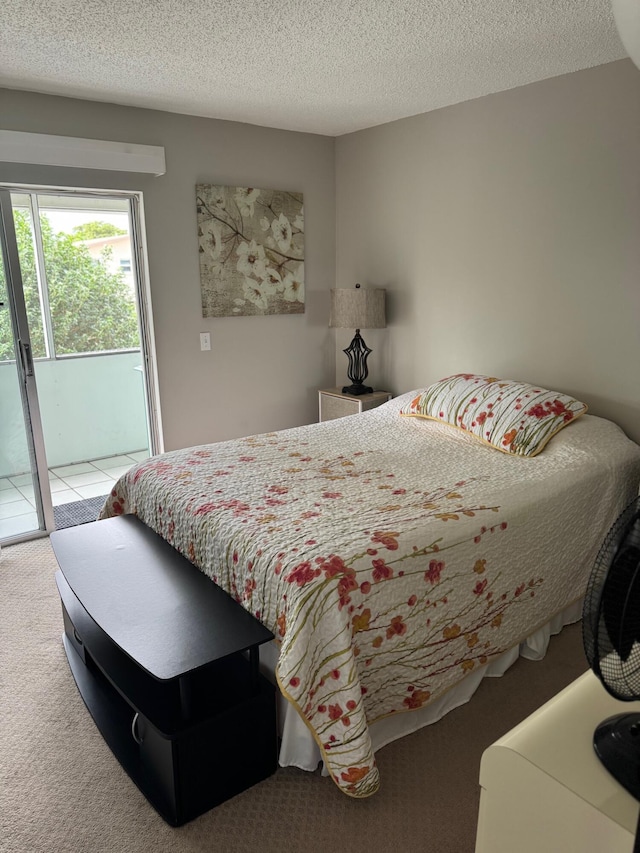 carpeted bedroom featuring access to outside and a textured ceiling