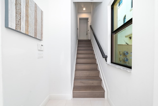 stairs with tile patterned floors