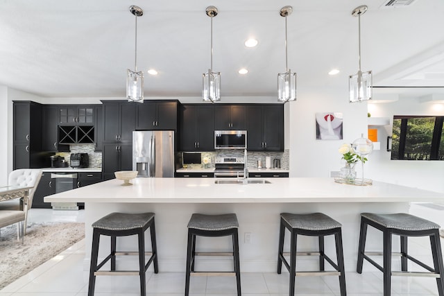 kitchen featuring a large island, hanging light fixtures, and appliances with stainless steel finishes