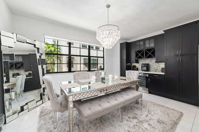 tiled dining room featuring a notable chandelier