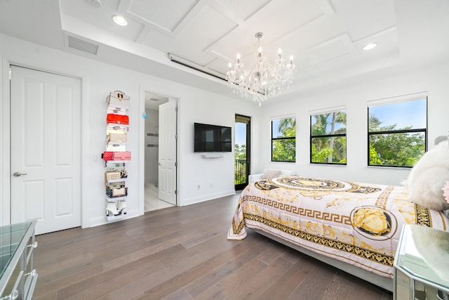 bedroom with dark hardwood / wood-style flooring and an inviting chandelier