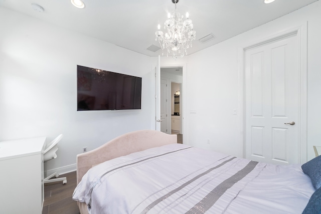 bedroom featuring dark hardwood / wood-style flooring and a chandelier