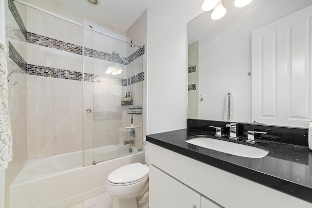 full bathroom featuring tile patterned floors, vanity, toilet, and shower / bath combination with glass door