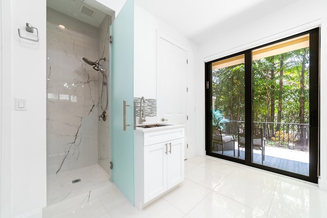 bathroom with vanity and tiled shower