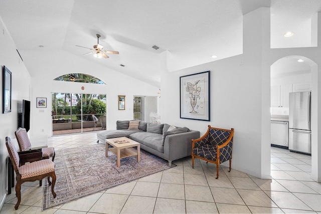1643 Oak Berry Cir, Wellington, FL 33414 - living room with ceiling fan, lofted ceiling, arched walkways, and light tile patterned flooring