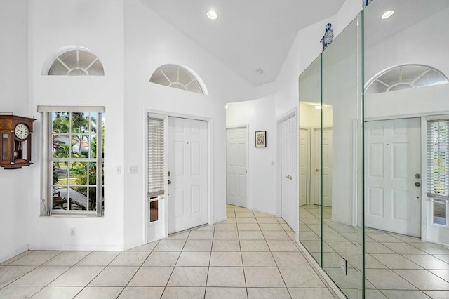 tiled foyer with high vaulted ceiling