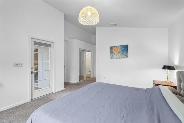 bedroom featuring carpet floors, an inviting chandelier, a closet, and lofted ceiling