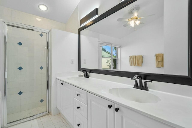 bathroom featuring ceiling fan, vanity, an enclosed shower, and vaulted ceiling