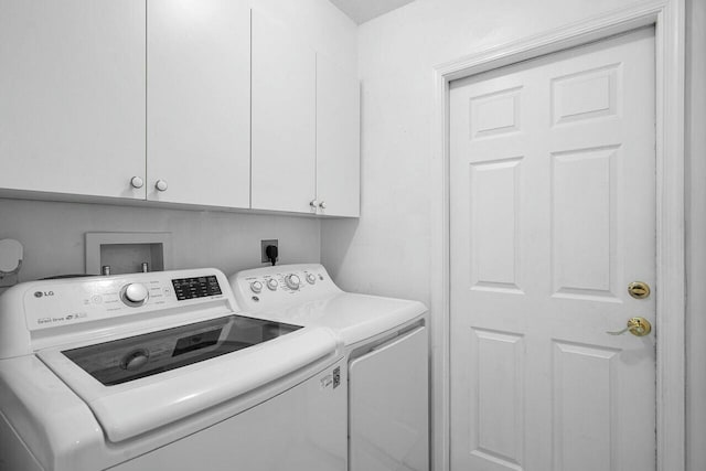 washroom featuring cabinets and independent washer and dryer