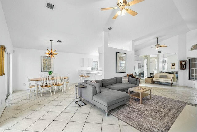 living room featuring ceiling fan, light tile patterned flooring, and vaulted ceiling