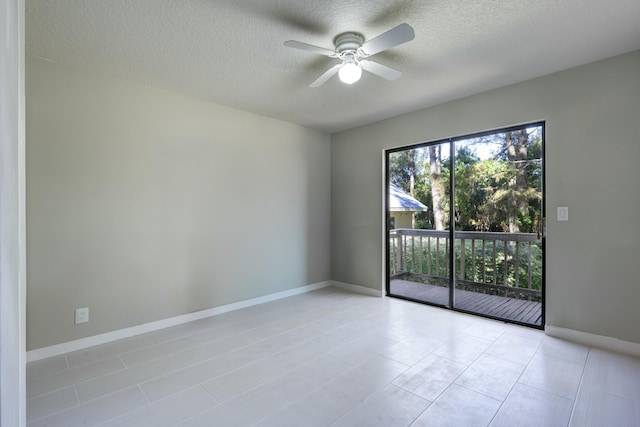 tiled spare room featuring ceiling fan and a textured ceiling