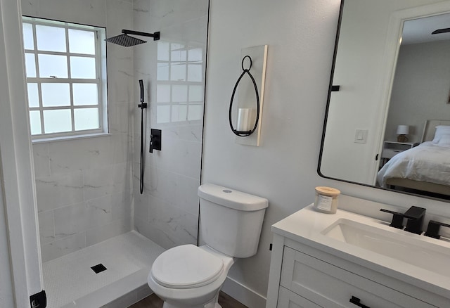 bathroom with plenty of natural light, a tile shower, and vanity