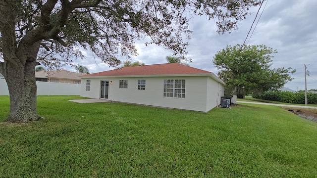 back of property featuring a yard