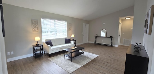 living room with dark hardwood / wood-style floors and lofted ceiling