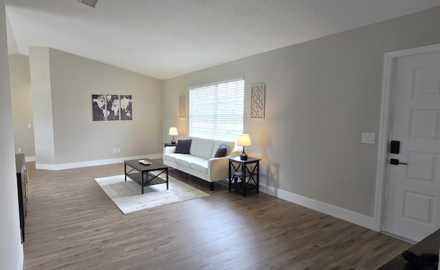 living room with hardwood / wood-style floors and vaulted ceiling