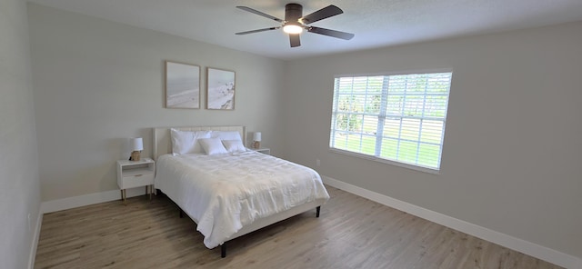 bedroom with hardwood / wood-style floors and ceiling fan