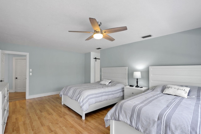 bedroom with light wood-type flooring and ceiling fan