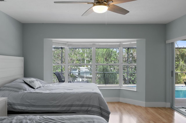 bedroom with ceiling fan, light hardwood / wood-style floors, and access to outside