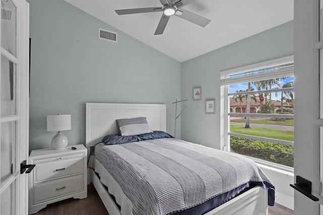 bedroom featuring ceiling fan, dark wood-type flooring, and vaulted ceiling