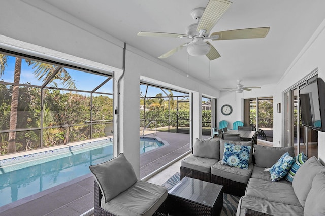 sunroom with ceiling fan and a swimming pool