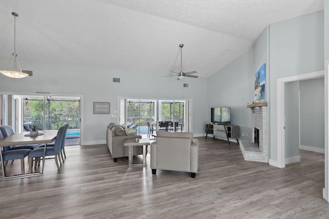 living room with plenty of natural light, wood-type flooring, and a fireplace