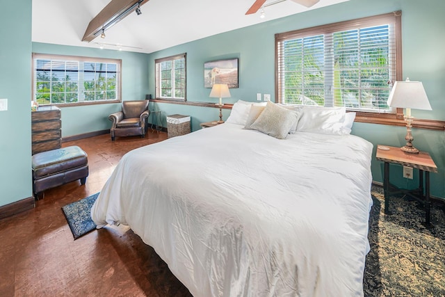 bedroom with vaulted ceiling with beams, ceiling fan, and multiple windows