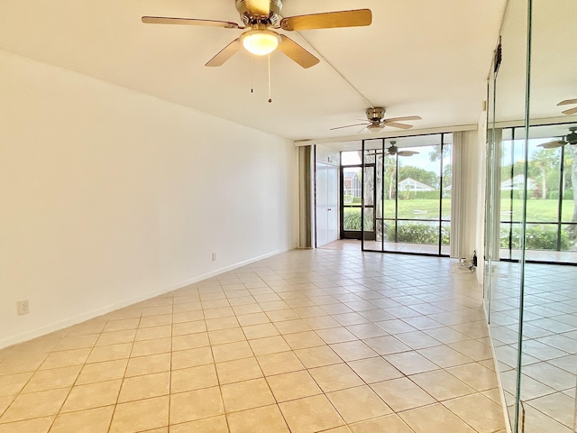 6928 Briarlake Cir Unit 104, Palm Beach Gardens, FL 33418 - unfurnished room featuring floor to ceiling windows, light tile patterned flooring, and a ceiling fan