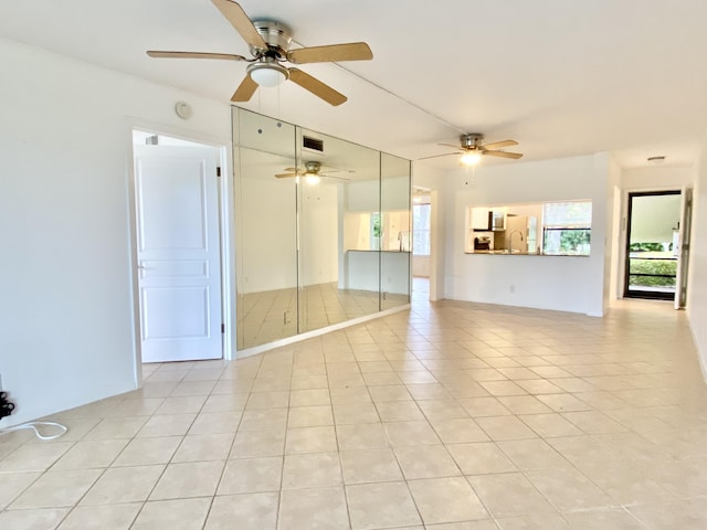 6928 Briarlake Cir Unit 104, Palm Beach Gardens, FL 33418 - spare room featuring light tile patterned floors and ceiling fan