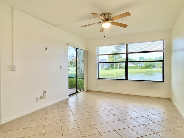 6928 Briarlake Cir Unit 104, Palm Beach Gardens, FL 33418 - spare room with a ceiling fan, light tile patterned flooring, and baseboards